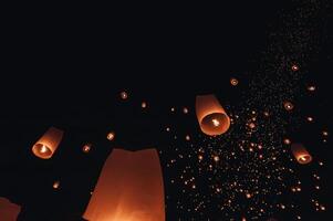 The beauty of the lanterns floating in the sky during the Yi Peng Festival and the Floating Lantern Festival in Chiang Mai Province, Thailand. photo