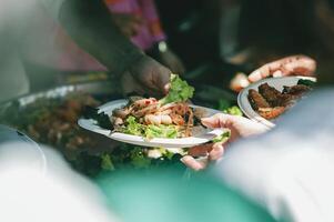 The hands of beggars receive donated food. concept of charity food for the poor photo