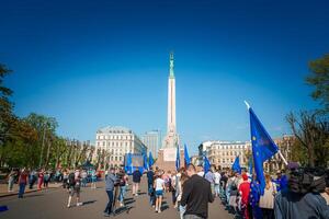 Vibrant Gathering in Old Town Riga, Latvia under Blue Sky photo