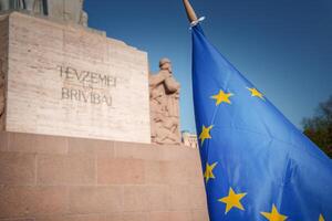 European Union flag with Freedom Monument in Riga, Latvia photo