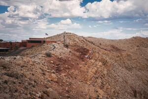 Rugged landscape with trail, hill, and facilities near Meteor Crater, Arizona. photo