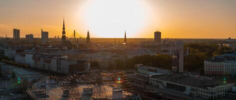 Aerial panoramic sunset over Riga old town in Latvia. Beautiful spring sunset over Riga. Golden hour fire sunset. photo