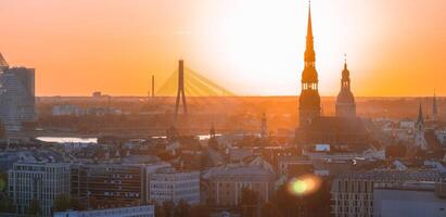 Aerial panoramic sunset over Riga old town in Latvia. Beautiful spring sunset over Riga. Golden hour fire sunset. photo