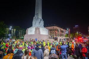 Vibrant Night Gathering in Riga, Latvia Freedom Monument Celebration photo