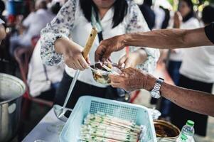 concept of charity food for the poor . the concept of life problems, hunger in society . Helping People With Hunger With Kindness. The hands of beggars receive donated food photo