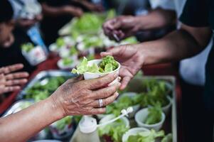 concept of charity food for the poor . the concept of life problems, hunger in society . Helping People With Hunger With Kindness. The hands of beggars receive donated food photo