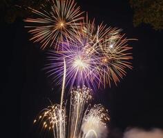 Fireworks explode in the dark sky celebrating the annual festival. photo