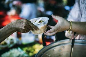 The concept of sharing. Participation in sharing food for the poor photo