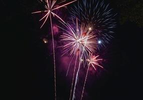 Fireworks explode in the dark sky celebrating the annual festival. photo