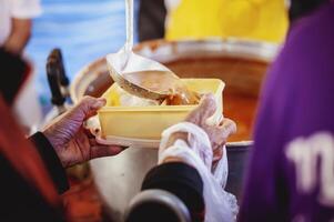 caridad concepto . donar comida a el mendigo. foto