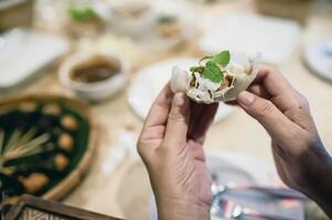 Nam Nueng, a Vietnamese dish, is a dish consisting of vegetable dough, salad, raw bananas, chili, garlic, and pork, then topped with a sweet dipping sauce. photo