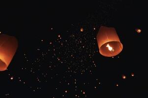 The beauty of the lanterns floating in the sky during the Yi Peng Festival and the Floating Lantern Festival in Chiang Mai Province, Thailand. photo