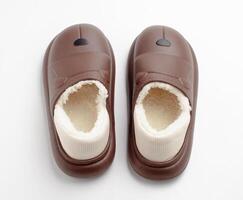 Brown leather shoes with soft fur inside on a white background. photo