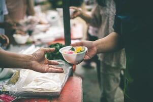 Helping donate free food to fill the stomachs of the poor the concept of starvation and hunger problems. photo