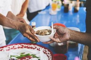 Hungry homeless people request free food donations from volunteers social concept of helping photo