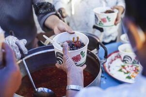 Homeless people reach out to receive free food that volunteers bring. to help alleviate hunger photo