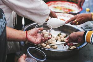 Volunteer to serve free food for the poor in a food donation center charity concept photo