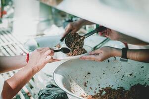 Volunteers offer free food to the poor. the concept of food sharing. photo