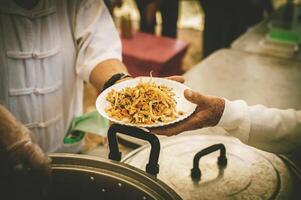 Volunteers offer free food to the poor. the concept of food sharing. photo