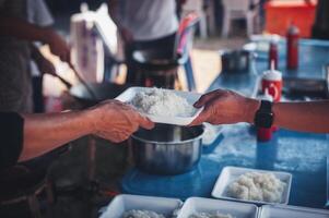 Sharing warm food for homeless and homeless people photo