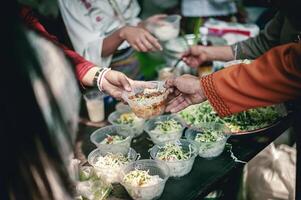 Feeding concept Homeless people offer free food from outdoor volunteers. photo