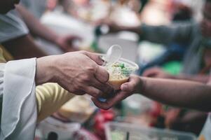 Sharing warm food for homeless and homeless people photo