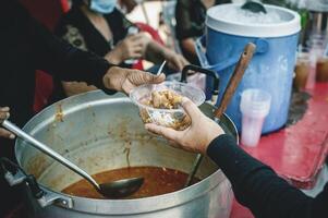 Volunteer concept to donate ready-to-eat food to the hungry and poor photo