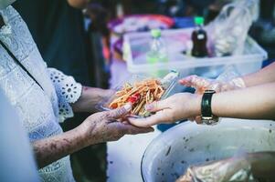 Hungry homeless people request free food donations from volunteers social concept of helping photo