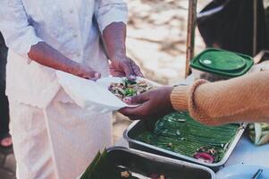 Hungry homeless people request free food donations from volunteers social concept of helping photo