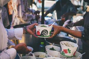 Hungry homeless people request free food donations from volunteers social concept of helping photo