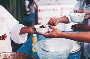 hambriento Vagabundo personas solicitud gratis comida donaciones desde voluntarios social concepto de Ayudar foto