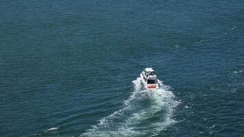 Foam path with waves. yacht from above. Ocean waves captured by drone above a boat video