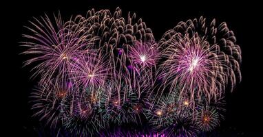 Colorful celebration fireworks isolated on a black sky background. photo