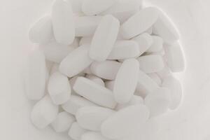 White pills in a jar photo