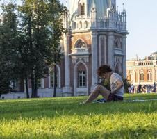 Moscow, Russia - 08.07.2023 - Young woman enjoying day out at Tsaritsyno Museum-Reserve. Outdoor photo