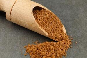 Ground nutmeg seasoning in a wooden scoop photo