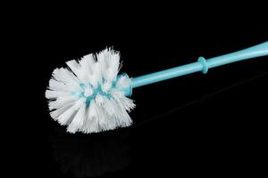 toilet cleaning brush isolate on black photo