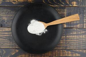 proteína polvo en un cuchara en un plato foto