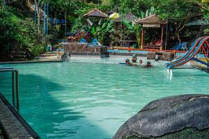 Jepara, Central Java, April 16, 2024 - top view from a swimming pool with green water surrounded by trees photo