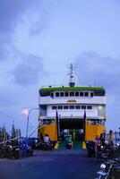 Jepara Central Java, April 7, 2024 - rear view of an inter-island crossing ship against the background of the evening sky with free space for photocopying. front view of the ship docked at the Jepara photo