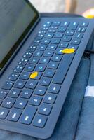 Close-up view of a keyboard for a tablet on a table, in an open room. photo