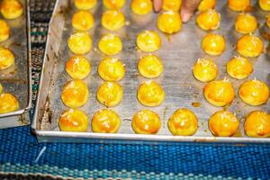 Close-up view of pineapple cakes arranged neatly in a baking pan. photo