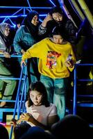 Indramayu, West Java, April 20, 2024 - people queuing to get off the fairgrounds in Indramayu at night. photo