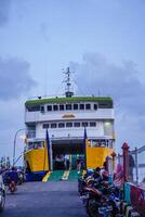 Jepara Central Java, April 7, 2024 - rear view of an inter-island crossing ship against the background of the evening sky with free space for photocopying. front view of the ship docked at the Jepara photo