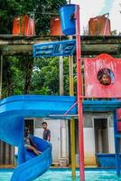 Jepara, Central Java, April 14, 2024 - swimming pool rides for children with colorful slides. photo