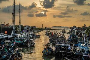 Jepara, Central Java, April 7, 2024 - Jepara fishing boats parked in a crowded harbor against the backdrop of the evening sky with empty space for advertising photo