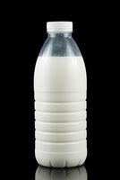 A bottle of milk on a black background photo