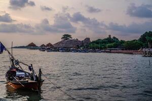 Fishing boats leaning on the seashore with the Kartini Beach tourism in Jepara, Central Java in the background. photo