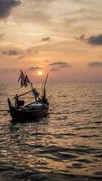 fishing boats on the sea against an orange sky at night with empty space for photocopies. photo