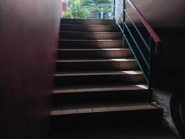 stairs leading upwards with sunlight effect, seen close to the point of view from below. photo